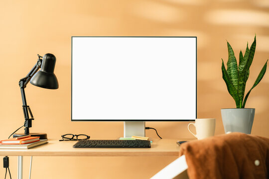 A computer with white screen on the table