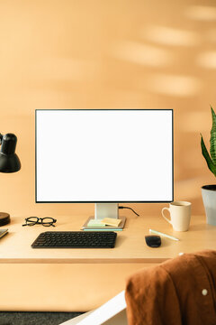 A computer with white screen on the table