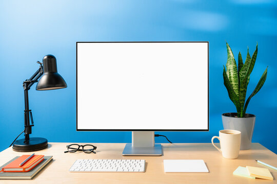 A computer with white screen on the table