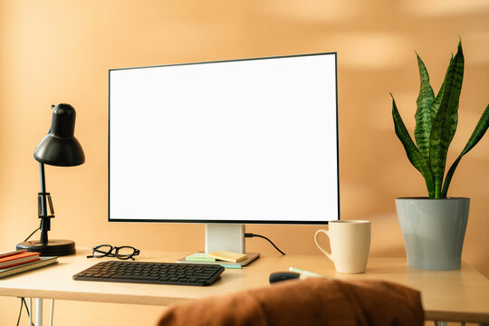 A computer with white screen on the table