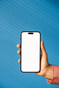 Woman's hand with a mobile phone with white screen