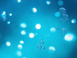 Bubbles floating in a bright blue underwater environment during daylight hours