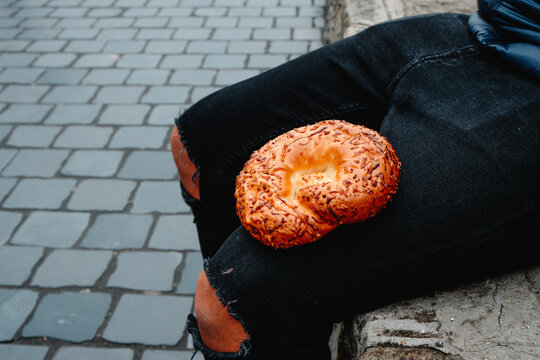 man with a cheese bagel on his lap in Budapest