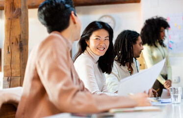 Diverse group of entrepreneurs in business meeting listening 