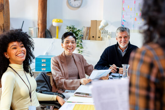 group of coworkers in business meeting listening to project leader