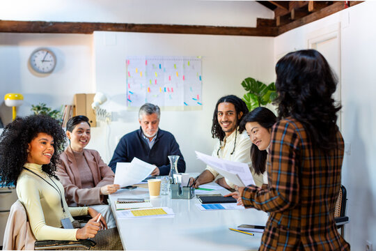 group of coworkers in business meeting listening to project leader
