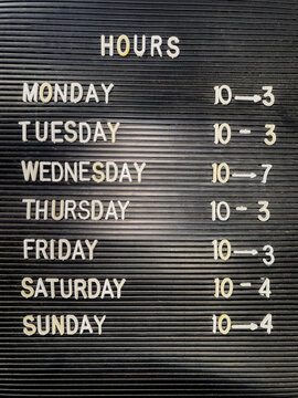 vintage Business Hours sign at store