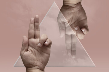 Collage with a glass triangle and two male hands