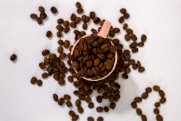 coffee grains falling into a cup or cupcake with coffee inside and symbols around it, creating a background