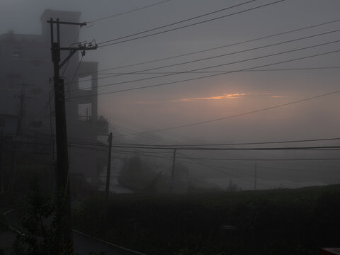 Sunset barely visible through heavy mist, Alishan, Taiwan.