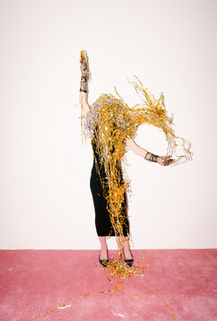 Celebratory Woman Covered in Gold and Silver Streamers