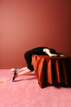 Woman in Black Dress Leaning on Round Table with Pink Balloon