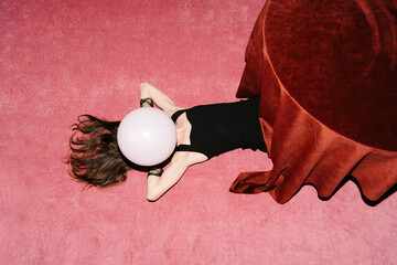 Surreal Woman with Balloon Head on Pink Carpet