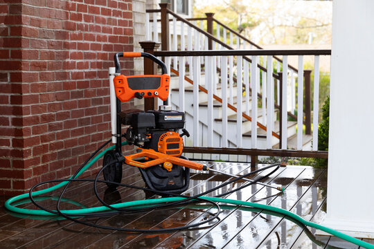 Gas operated Pressure washer on porch of home 