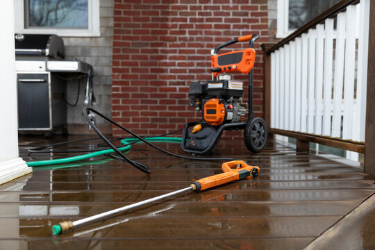 Pressure washer hose on porch of home 