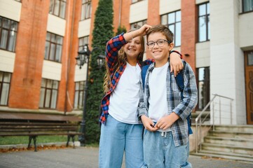 Portrait of smiling school kids standing at school yard