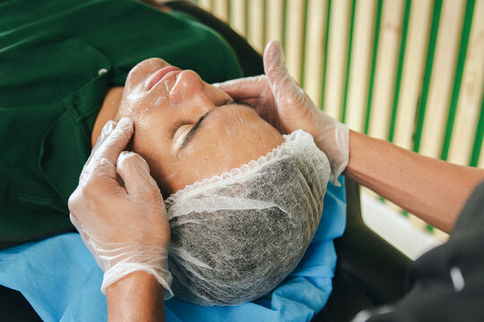 Man giving a facial massage to a man