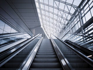 Fototapeta premium Modern Escalator in a Futuristic Glass Building Interior