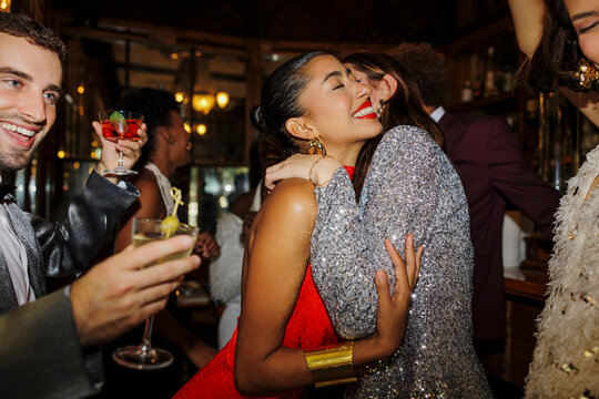 Cheerful friends hugging, celebrating new year's eve at disco ugc