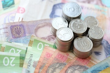 Few stacks of ukrainian money coins lies on old hryvnia banknotes