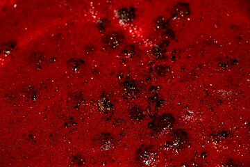close up of blackberry jam boiling, texture or landscape close up.