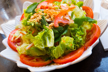 Close up view of chicken salad with greens and tomatoes