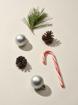 Winter holiday decorations with ornaments, pinecones, and candy cane