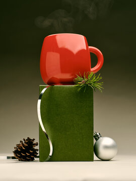 Red mug atop green gift box with pinecone and ornament for holidays