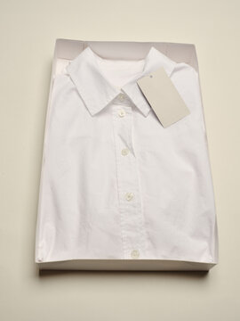 New white dress shirt neatly packaged on a plain surface