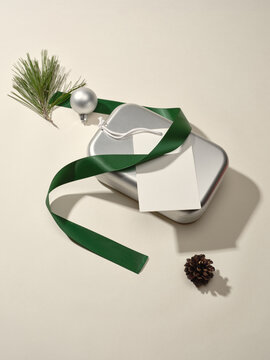 Holiday gift box arrangement with ribbon and pine decoration