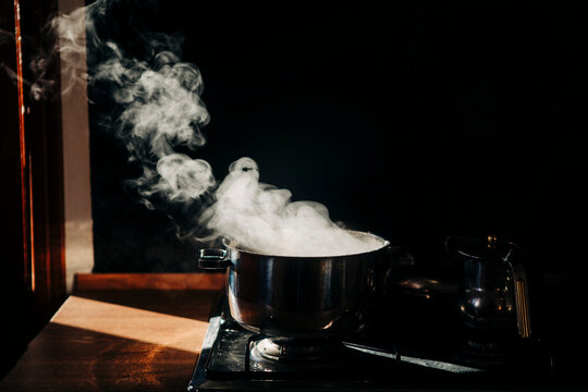Steam rising dramatically from a pot