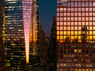 Reflective Skyscrapers with Sunset Colors in Urban Nightscape