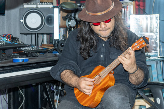 Latin man playing ukulele