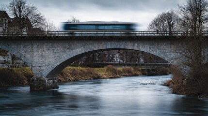 Fototapeta premium A train crossing a river on a bridge, great for transportation and infrastructure images