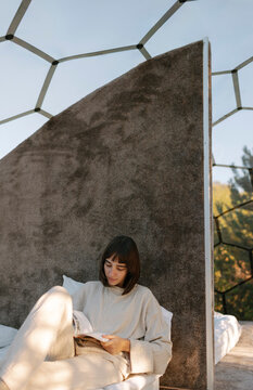Woman Reading Book On Bed