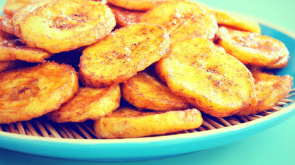Fried banana slices on blue plate.