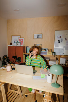 Freelancer taking notes working from home office