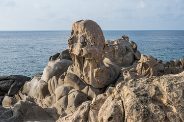 Wind-eroded rocks illuminated by the sun in the beautiful Punta Molentis beach in Villasimius