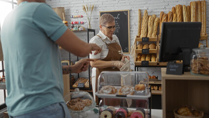 Woman serving bread to male customer in bakery with pastries and baguettes displayed on shelves, featuring indoor cozy shop setting.