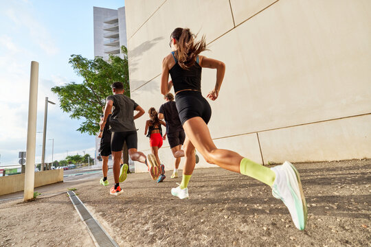 Runners sprint in an urban area