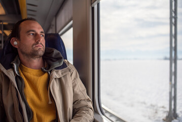 Man winter candid portrait of man traveling on train 
