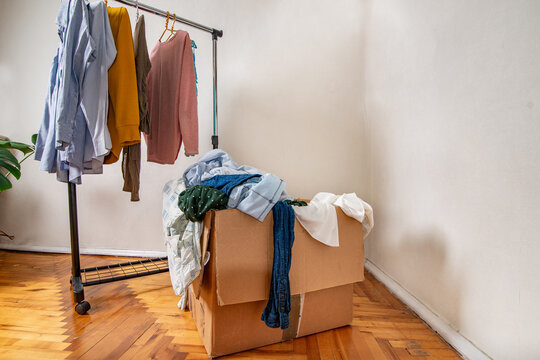 Second-hand clothes on the rail and sorted in a box