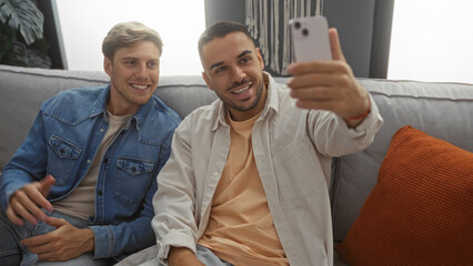 Fototapeta premium Men friends taking selfie in cozy living room showcasing cheerful relationship indoors