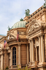 A building with a green dome and a flag on top