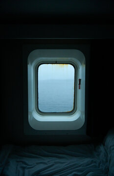 Ennui and depressing dull voyage view from ship's cabin porthole