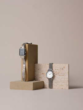 Elegant Silver Watches Displayed on Geometric Stone Stands