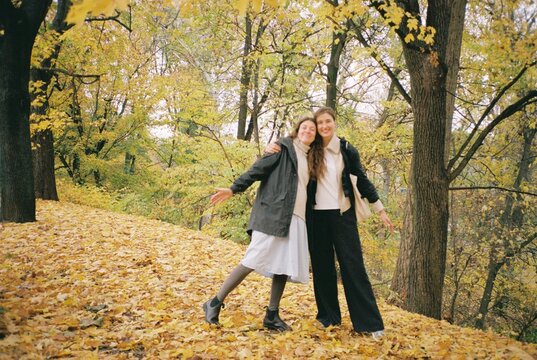 Hugging sisters in the autumn park
