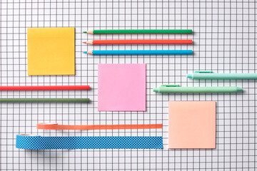 Colorful Stationery Arranged Neatly on a Graph Paper Background