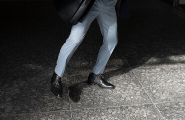Businessman walking in sunlight