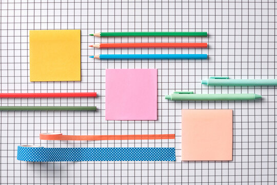Colorful Stationery Arranged Neatly on a Graph Paper Background